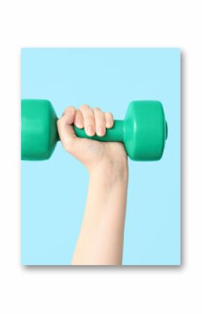 Female hand with dumbbell on color background, closeup