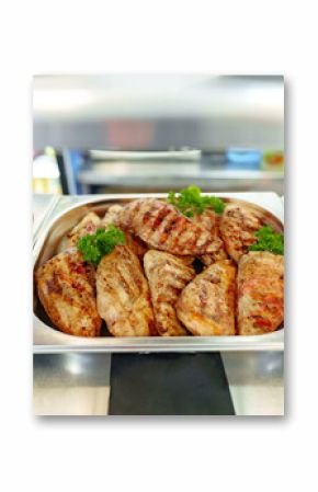 Grilled Chicken Breasts and Pork Cutlets Served in a Buffet Setting