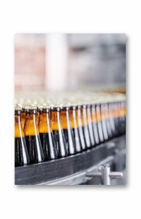 Automated modern beer bottling factory line with glasses bottles on conveyor. Banner Brewery industry food manufacturing, sunlight