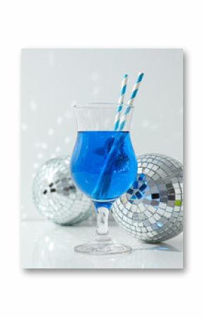 Blue cocktail with straws in glass and disco balls on white background