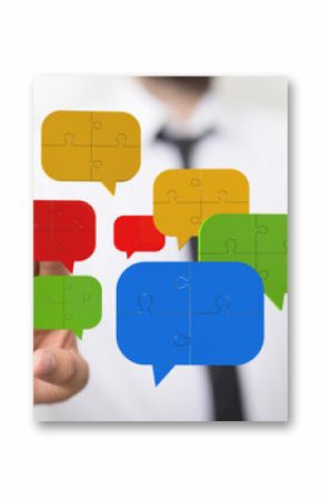 Image of puzzle pieces forming speech bubbles, symbolizing teamwork and effective communication.