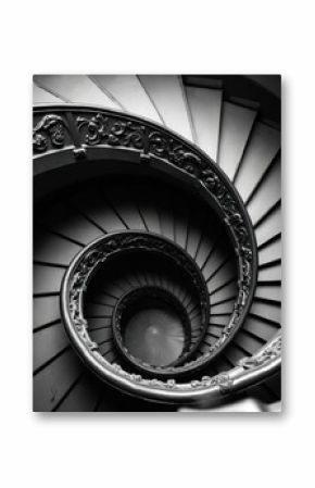 Vintage spiral staircase with intricate details. Architectural design with carved, decorative elements, circular shape leads upwards. Classic building interior, black, white, monochrome, abstract