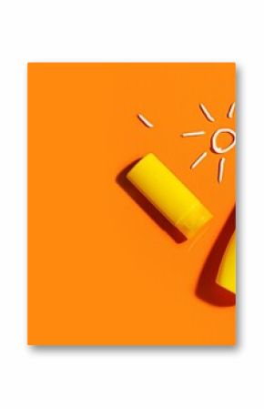 Bottles of sunscreen cream on orange background with space for text