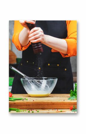 skilled chef grinds pepper in mill prepares healthy dish using fresh eggs and utensils in a bright and lively kitchen filled with greenery.