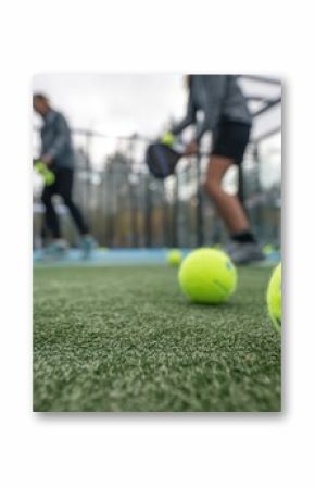 An action shot of padel players enjoying a game with innovative recycled padel balls emphasizing environmental responsibility in sports. Perfect for illustrating sustainability in athletic