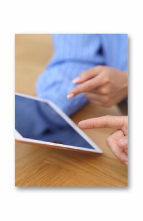 Business partners working with tablet at wooden table, closeup