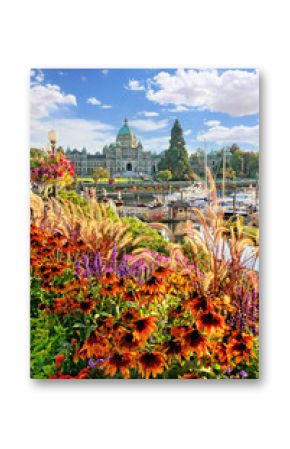 Beautiful harbor view with colorful autumn flowers and the British Columbia parliament building in the background, Victoria, Vancouver Island, BC, Canada