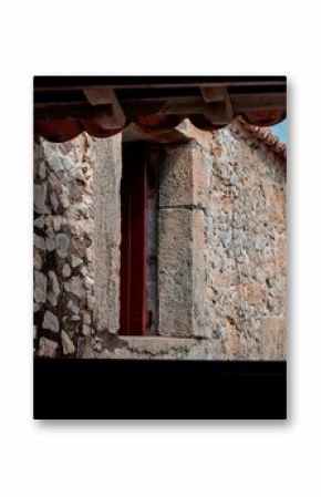 Close-up view of an old building through a window from a neighboring building