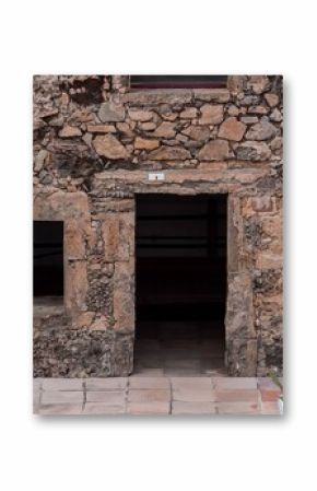 Close-up of an old building's stone facade with various shaped stones