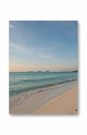 Secluded shoreline with ocean view and soft pastel sky.