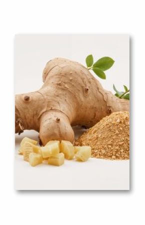Close-up image of entire and chopped ginger root paired with fresh leaves and ground ginger for kitchen use