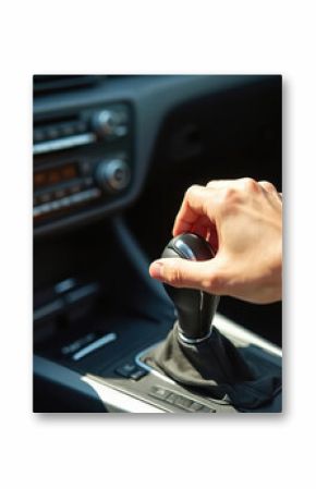 Driver hand shifts automatic transmission gear stick in car. Close-up view of hand on gear knob, dashboard, steering wheel in bright sunlight. Effortless driving experience, modern auto interior.