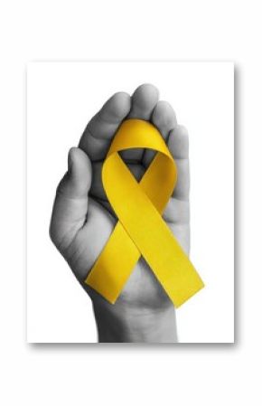 Hand holding a vibrant yellow ribbon, symbolizing the ongoing fight against childhood cancer and sarcoma, embodies hope and solidarity
