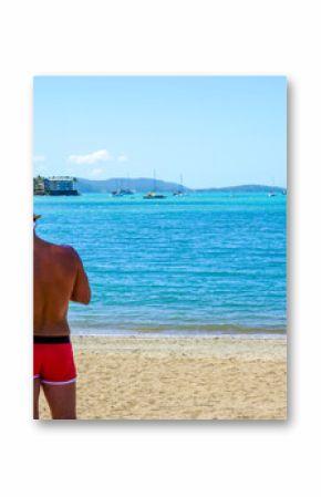 Couple in Santa Hats Celebrating Christmas on a Tropical Beach. Concept of Holiday Travel, Seasonal Celebration, and Love in Paradise.