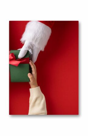Santa Claus giving a green wrapped present to a child on a red festive background