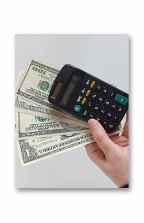 Hand holding calculator and US dollar bills – Financial planning and budgeting concept