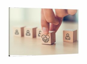 Empathy in leadership concept. Wooden block symbolizing empathy and partnership among blocks representing individuals, emotional intelligence and trust in workplace leadership and team collaboration.
