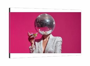 Disco ball head fashionista in sequined blazer holding cocktail against pink backdrop