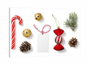 Collection of Christmas-themed elements on a transparent background, featuring a red and white candy cane, gold jingle bells, spruce branches, pine cones, a blank gift tag and festive candy ornament. 
