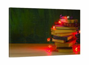 giving books for christmas,christmas  gift,present,reading,literature,education, christmas,holiday concept with heap of books, christmas lights and decoration