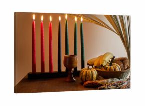 Kwanzaa Table Setting. A festive Kwanzaa display with Kinara, fruits, and vegetables