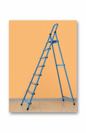 Blue stepladder near orange wall