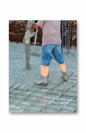 Construction worker pouring concrete on reinforcing steel mesh