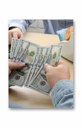 Client counting money at table in currency exchange, closeup