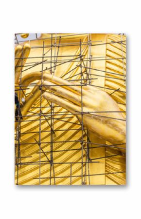 Painters are painting big golden Buddha statue under construction in Thai temple.