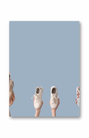 Women with stylish shoes on light background