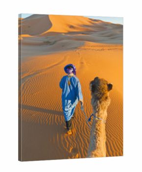 Berber walking with camel at Erg Chebbi, Morocco
