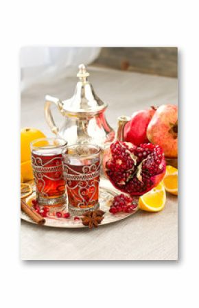 Traditional arabic tea with metal teapot and fruits