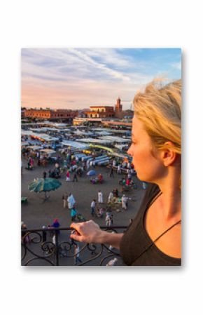 Female traveler enjoying view of Jamaa el Fna market square, Marrakesh, Morocco, north Africa. Jemaa el-Fnaa, Djema el-Fna or Djemaa el-Fnaa is a famous market place in Marrakesh's medina.