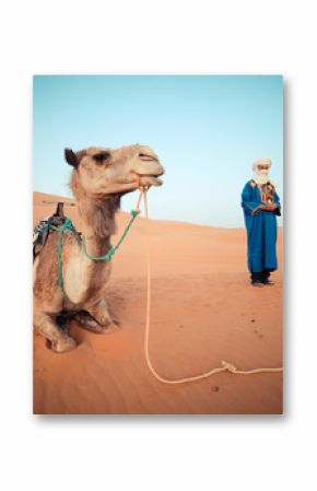 Moroccan berber watching the camel caravan at sunrise in the Sahara Desert 