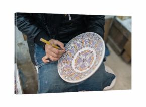 Moroccan potter at work in a pottery shop  