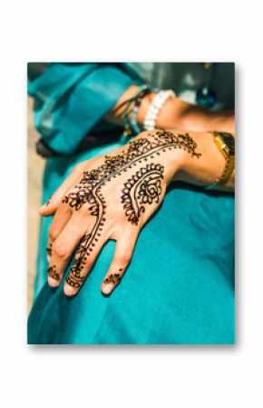 woman hands in process of henna tattoo