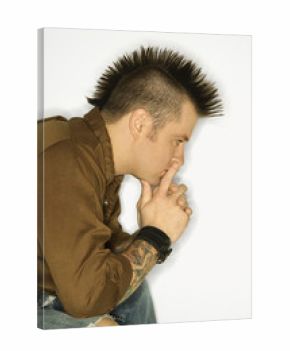Caucasian man with tattoos and mohawk.