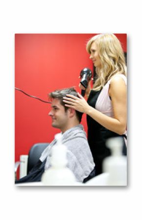 Blond hairdresser drying her customer's hair