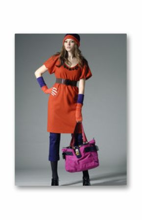 Fashion girl with bag posing in the studio