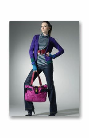 Fashion girl with bag posing in the studio