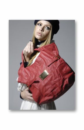 Fashion girl with red big bag posing on gray background