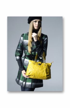 Fashion girl with bag posing in the studio
