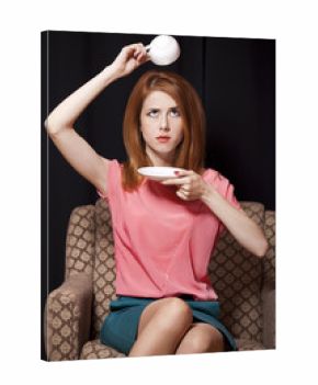 Surprised redhead girl with cup of coffee. 70s