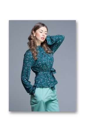 cute woman in casual summer outfit posing in the studio