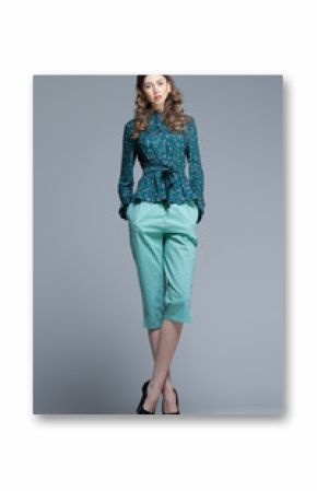 cute woman in casual summer outfit posing in the studio
