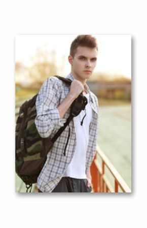 Outdoor lifestyle portrait of handsome guy with backpack