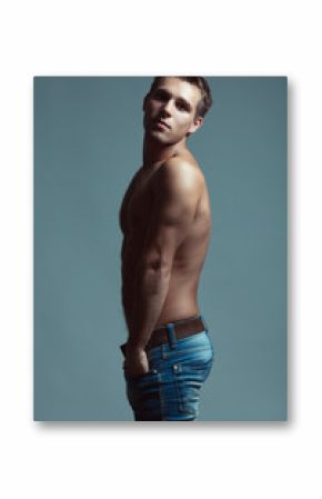 Handsome muscular male model with nice abs in blue jeans