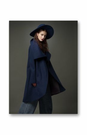 fashion model woman coat and hat urban style pose on color