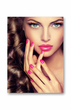 Beautiful model brunette with long curled hair . Hairstyle wavy curls . Crimson nails  manicure .Makeup   color fuchsia . 