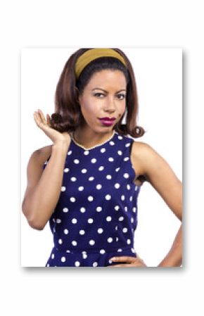 Black female wearing a blue vintage polka dot dress on a white background